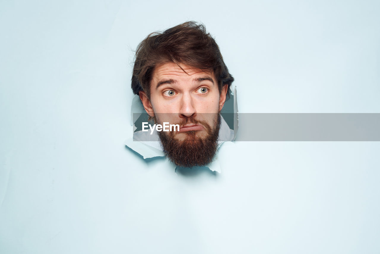 beard, one person, portrait, facial hair, adult, men, indoors, studio shot, looking at camera, human hair, headshot, copy space, moustache, human face, front view, young adult, brown hair, hairstyle, looking, human head, contemplation, serious, person, emotion, nose