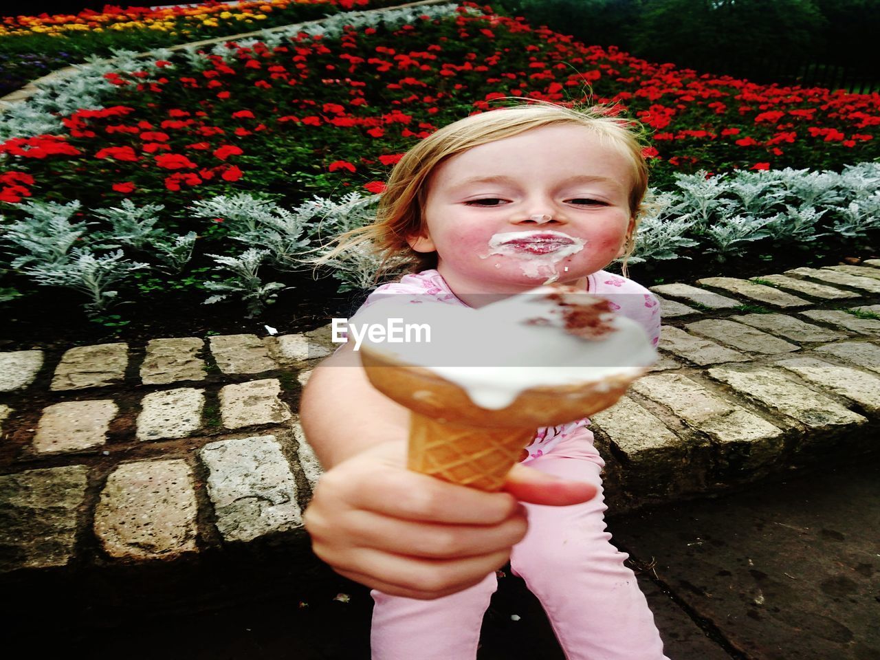 CLOSE-UP OF CUTE GIRL HOLDING ICE CREAM CONE