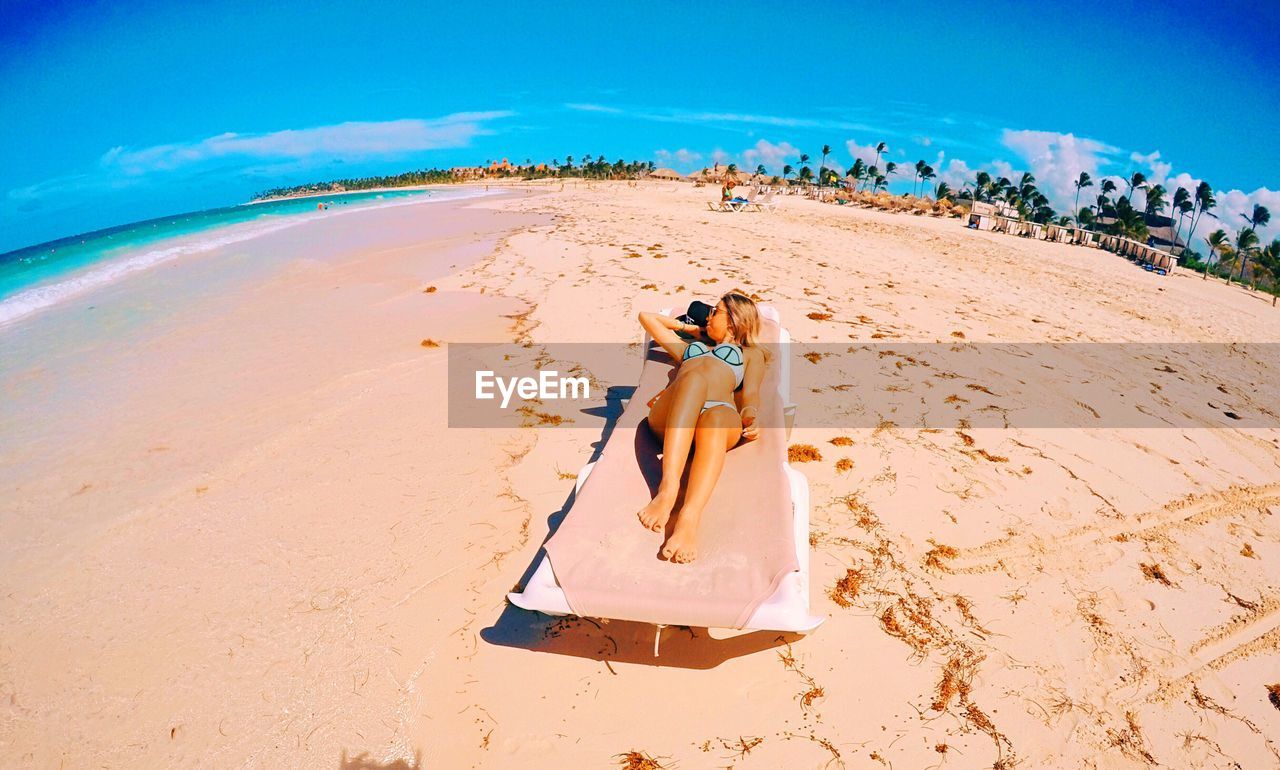 High angle view of woman relaxing on beach