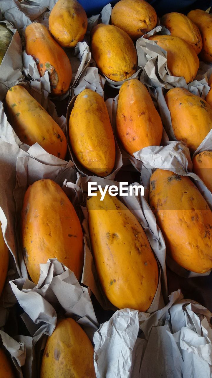 Full frame shot of papayas in paper