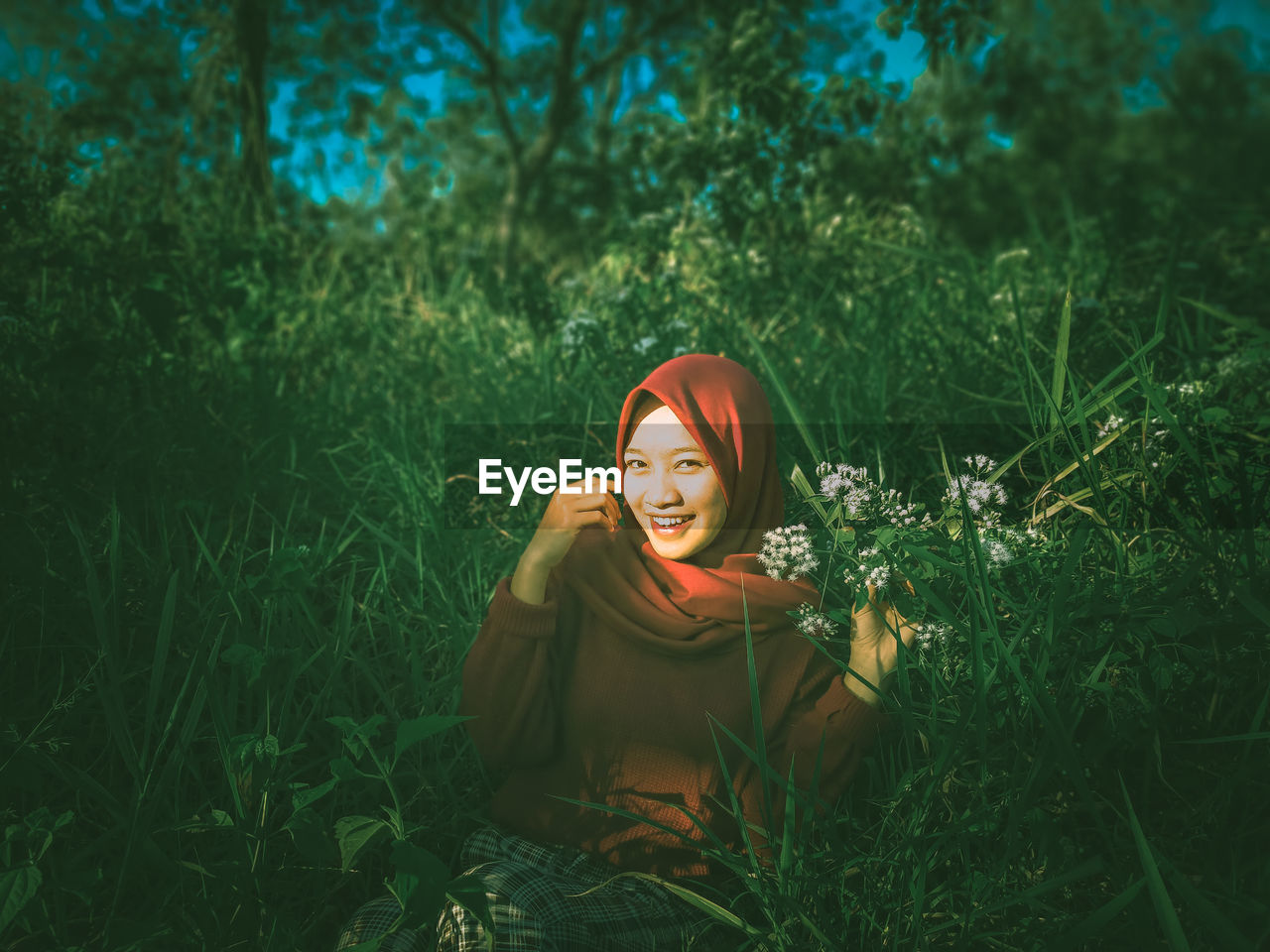 Portrait of a smiling young woman on field