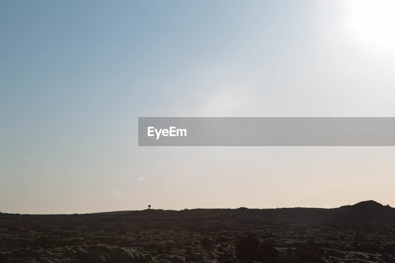 Scenic view of silhouette landscape against clear sky during sunset