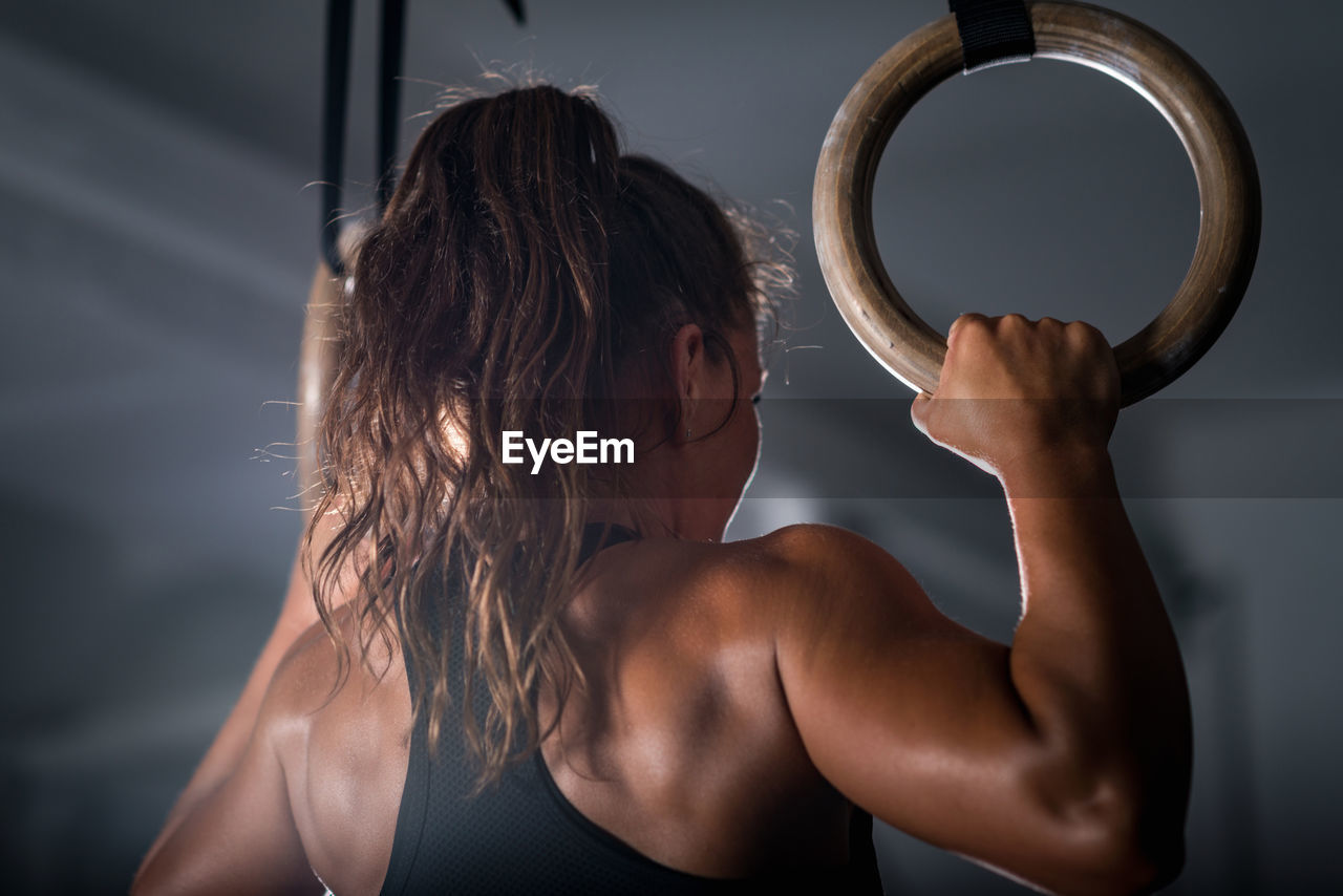 Rear view of athlete exercising in gym