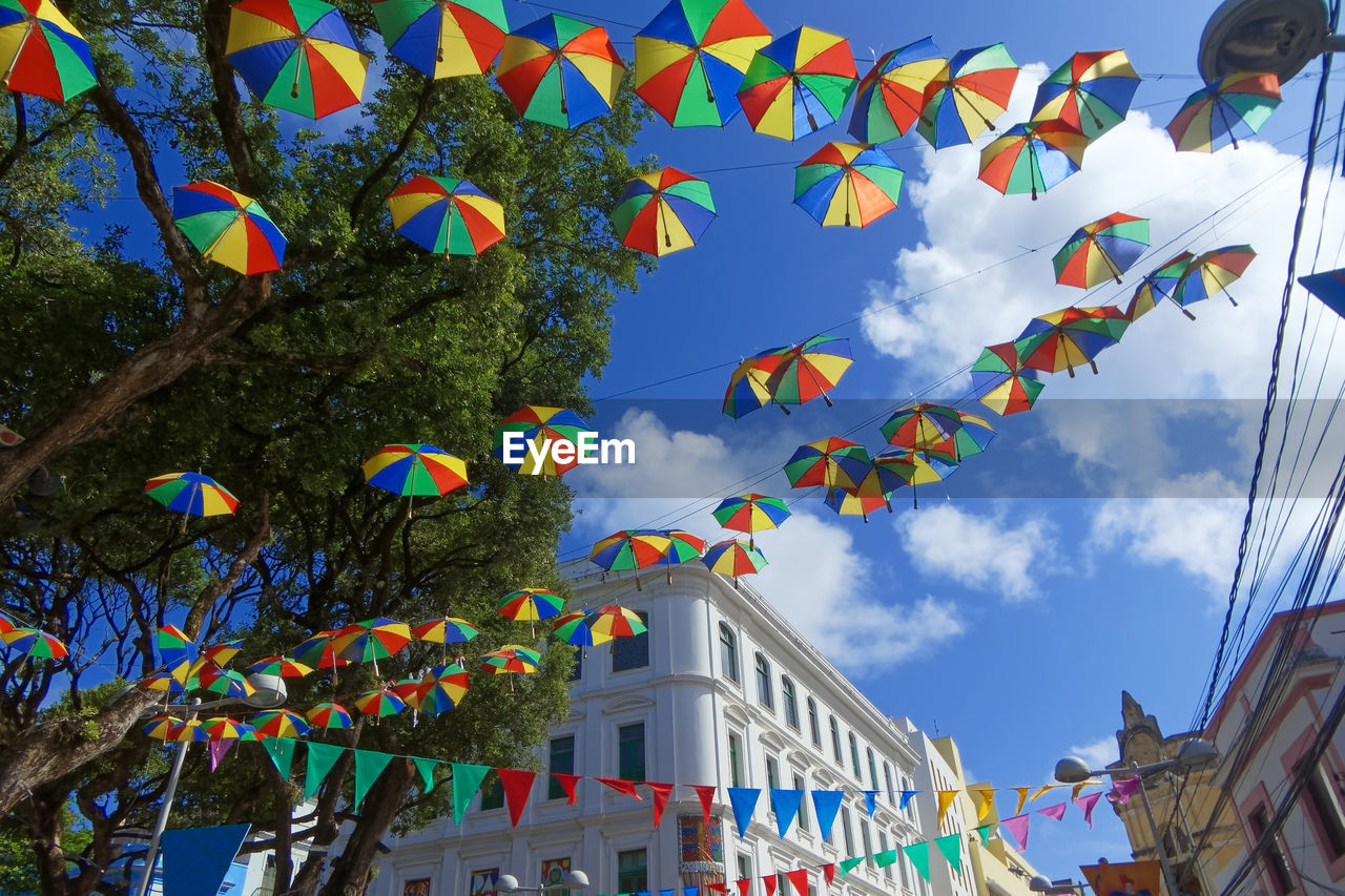 LOW ANGLE VIEW OF FLAGS HANGING ON BUILDING