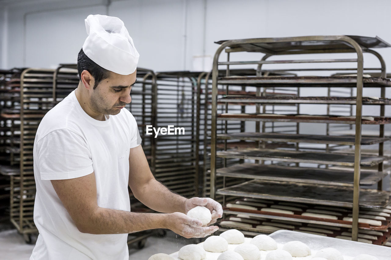 Baker making bread in commercial kitchen