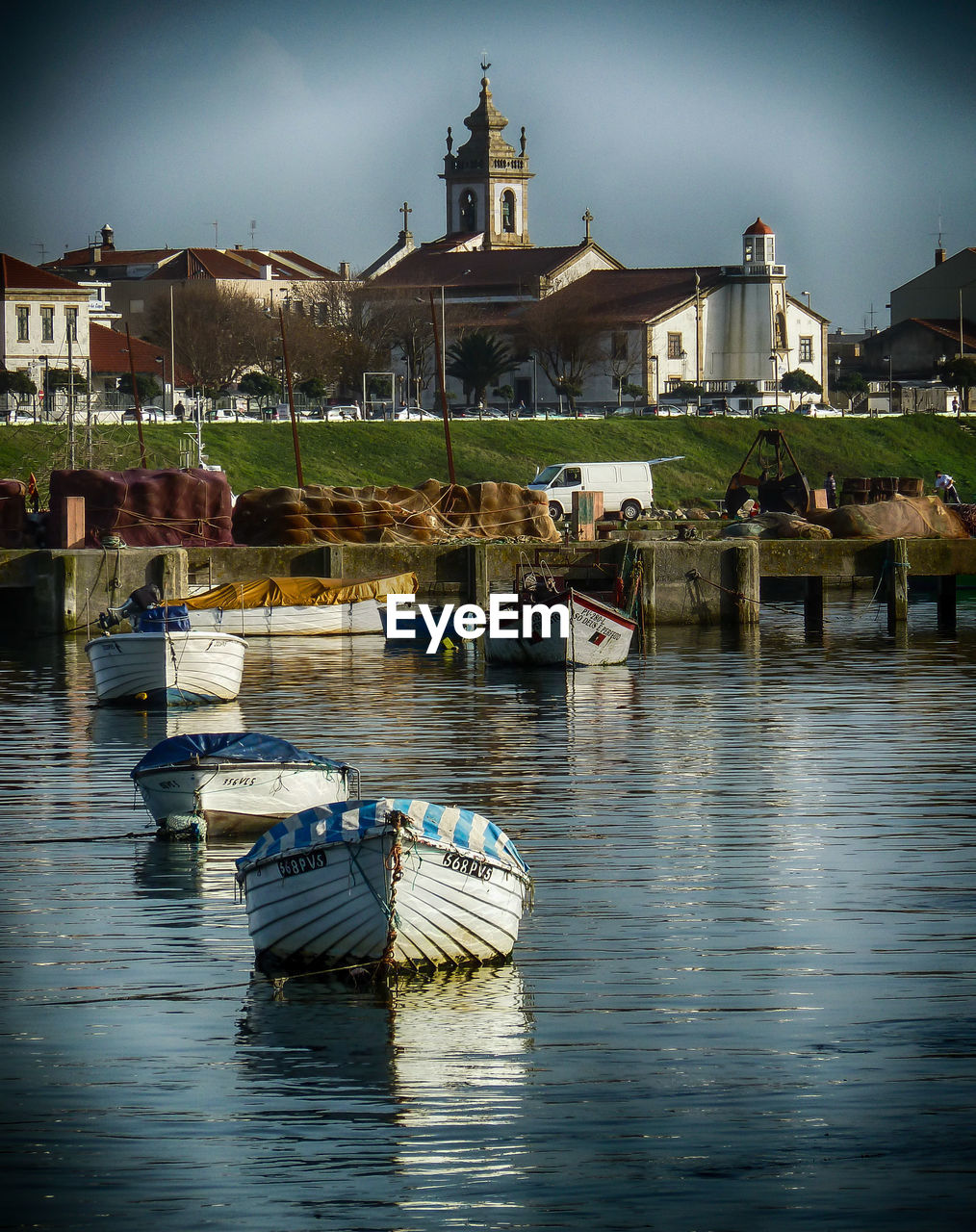 Boats at port against buildings