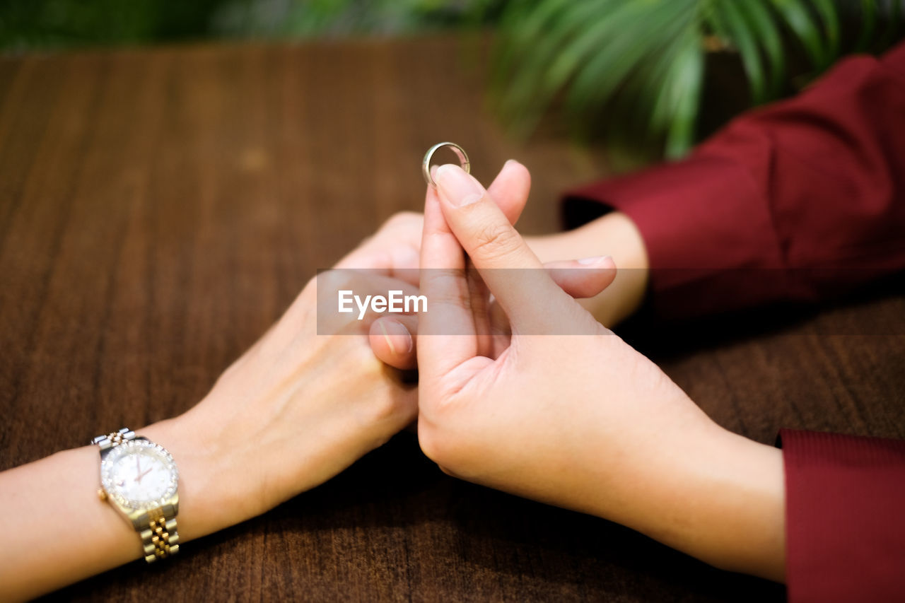 Close-up of couple holding hands