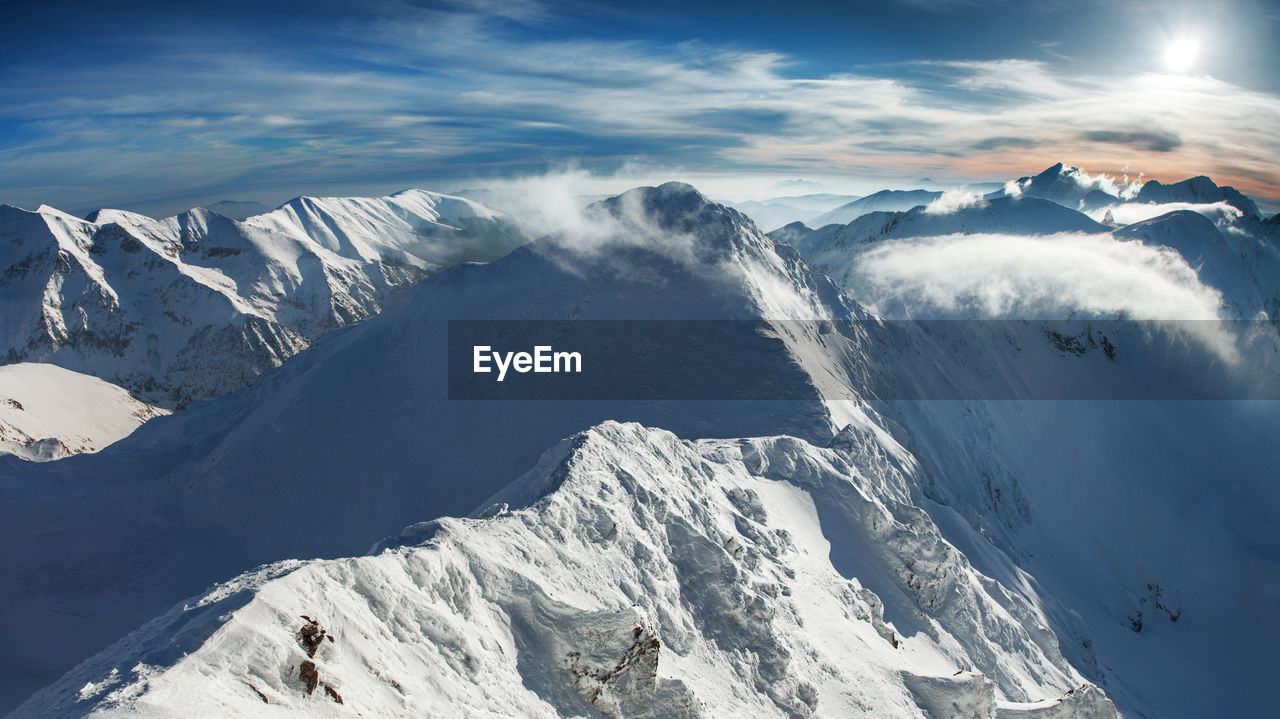 Scenic view of snowcapped mountains against sky