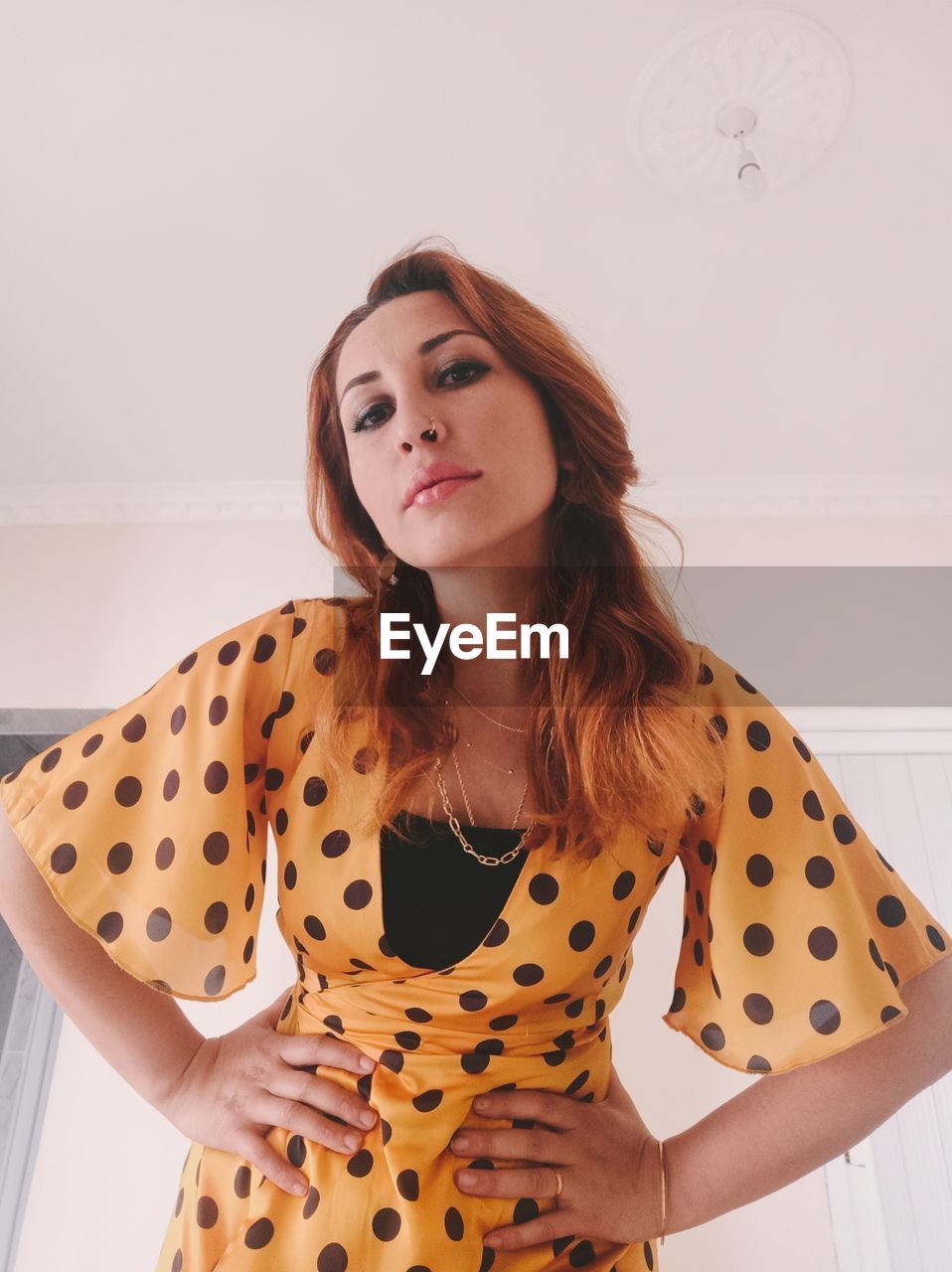 one person, women, adult, pattern, polka dot, young adult, portrait, fashion, long hair, hairstyle, indoors, clothing, spotted, front view, brown hair, looking at camera, standing, waist up, lifestyles, female, looking, sleeve, photo shoot, smiling, collar, redhead, brown, casual clothing, emotion, dress, elegance, copy space, happiness, cool attitude