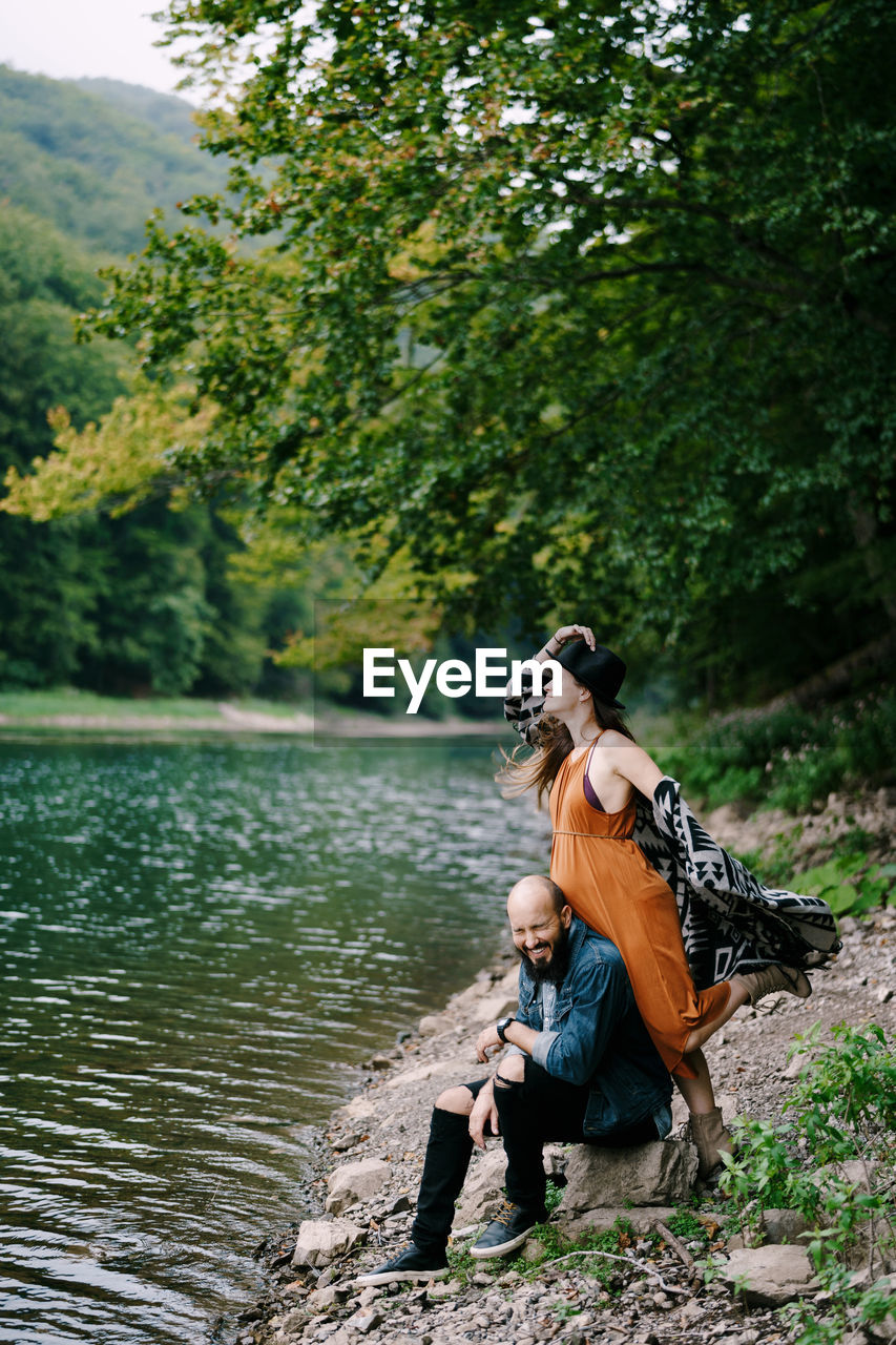 WOMAN SITTING ON A LAKE