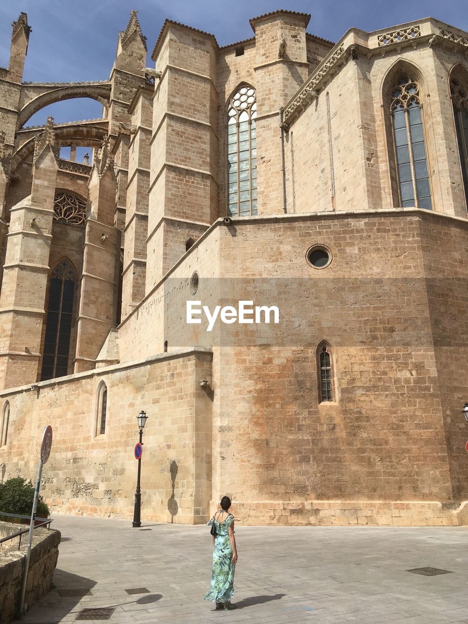 Rear view of woman walking towards cathedral