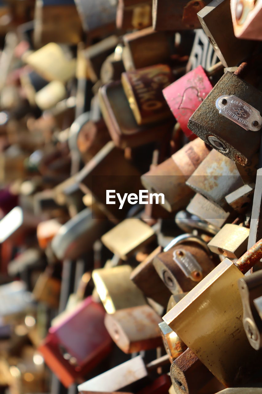 large group of objects, abundance, no people, variation, focus on foreground, backgrounds, padlock, love, indoors, close-up, full frame