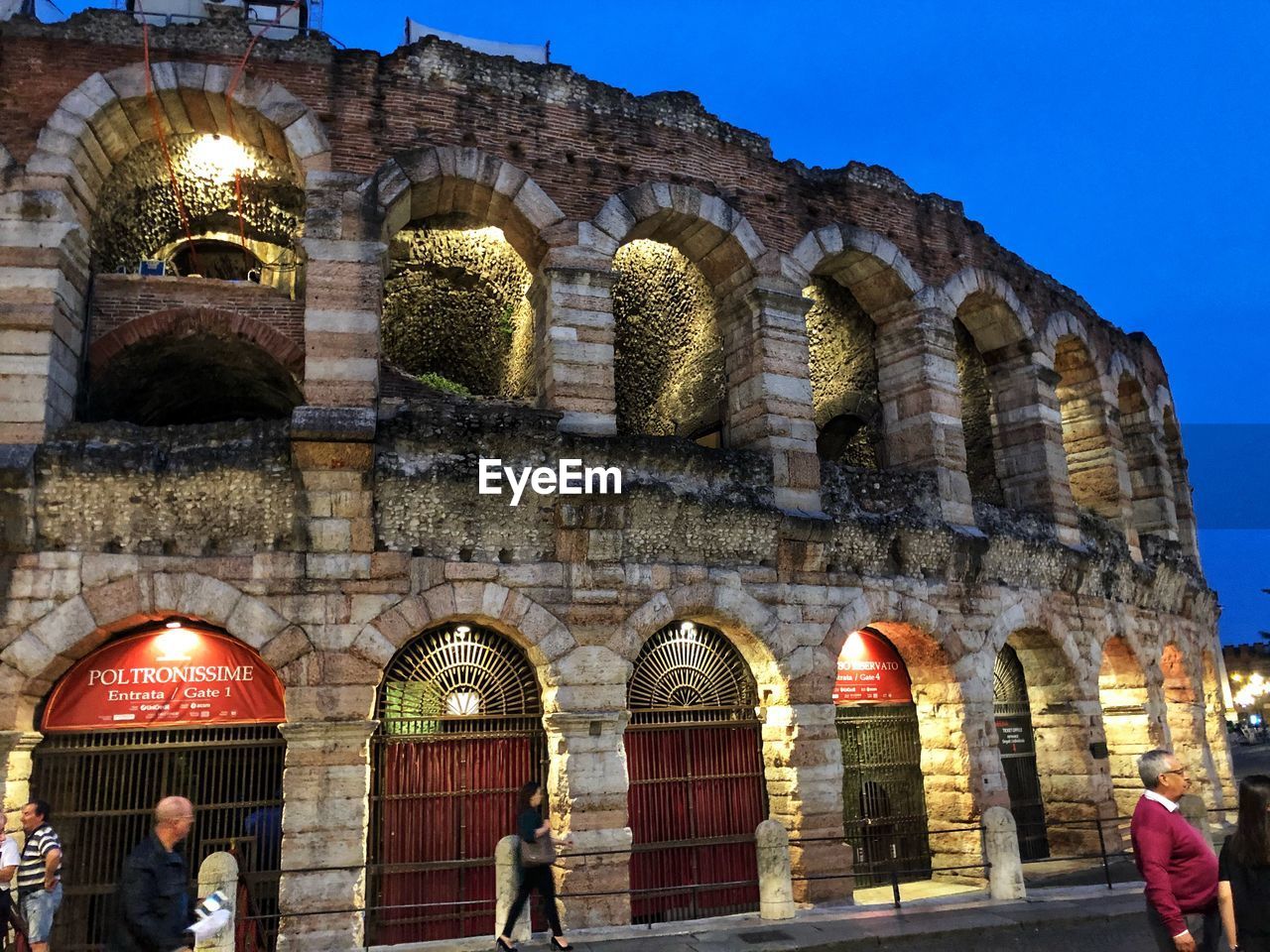 LOW ANGLE VIEW OF PEOPLE AT HISTORICAL BUILDING