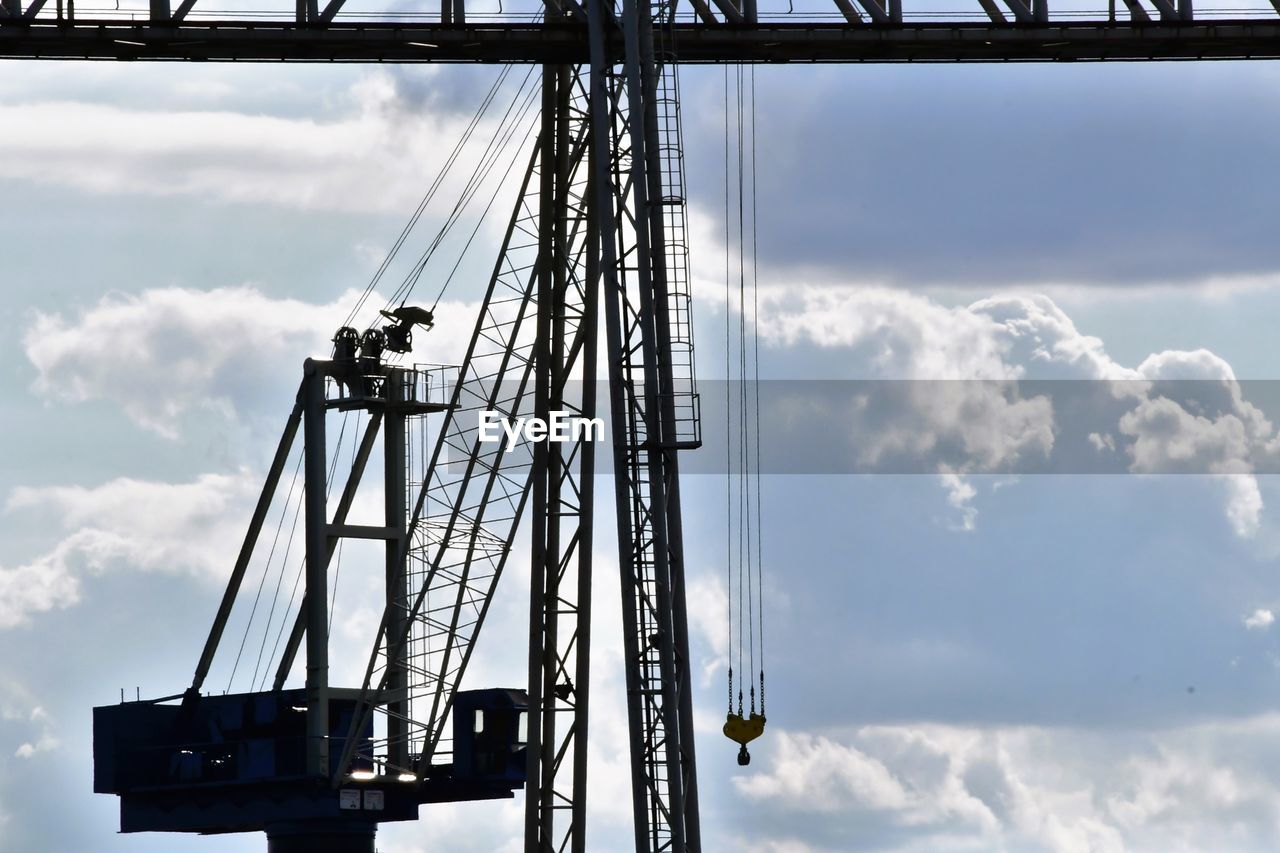 cloud, sky, industry, architecture, nature, machinery, transportation, crane - construction machinery, vehicle, construction equipment, built structure, outdoors, no people, low angle view, day, business, mast, electricity, water, freight transportation, silhouette, cloudscape, construction industry, business finance and industry, metal, unloading, transport, mode of transportation, shipping