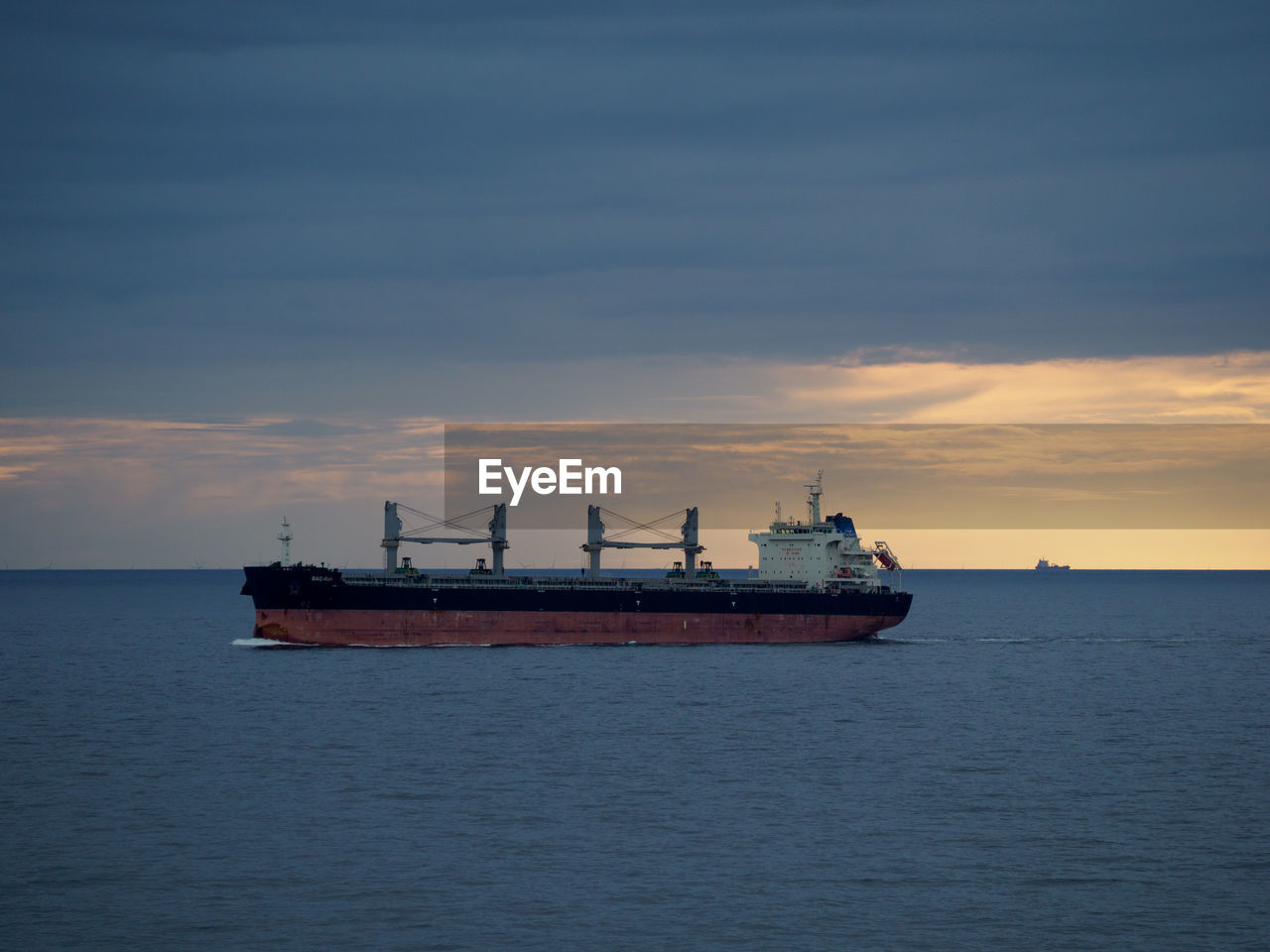 SHIP IN SEA AGAINST SKY AT SUNSET