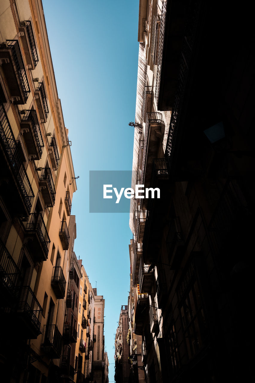 Low angle view of buildings against clear sky in city