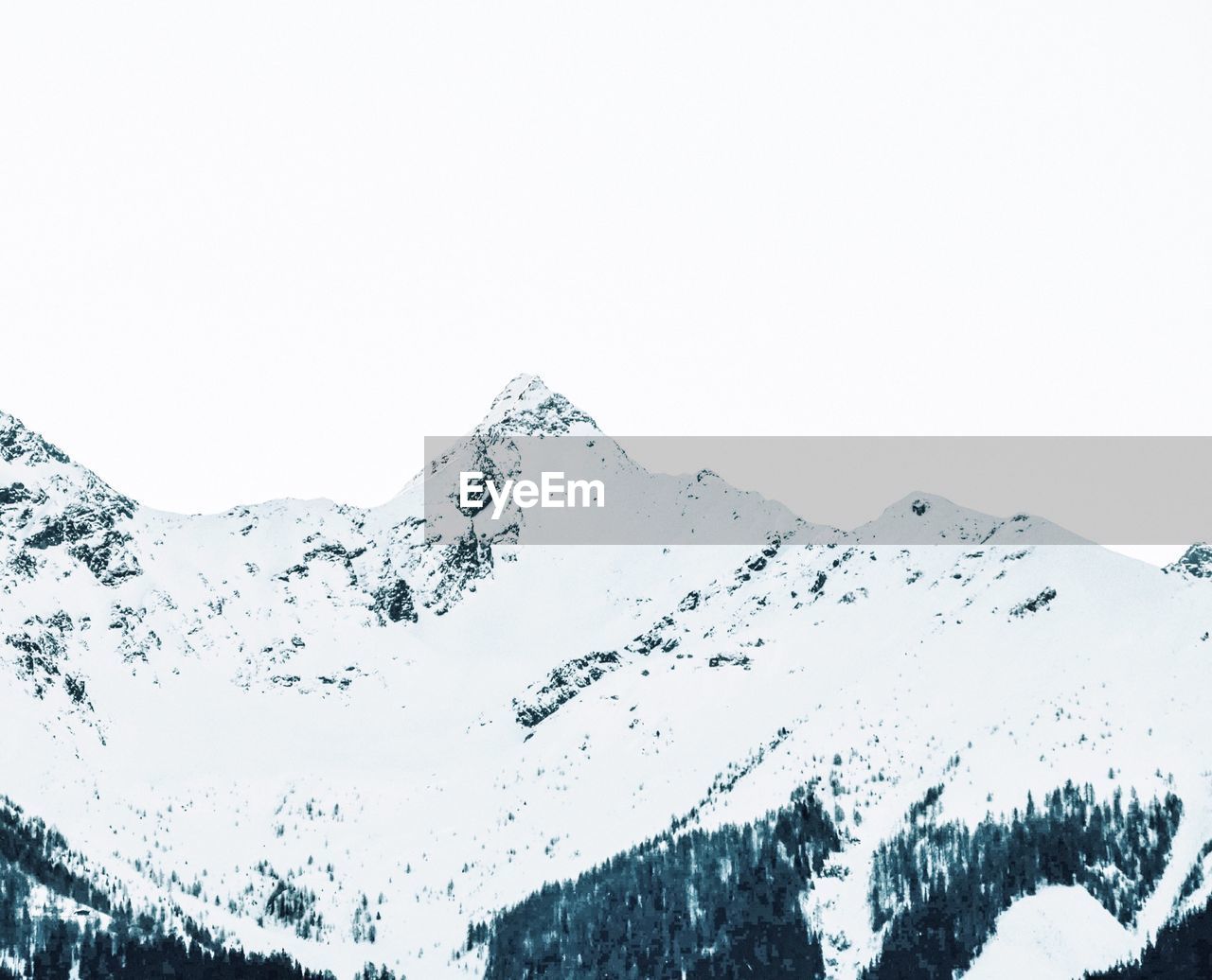 Aerial view of snowcapped mountain against clear sky