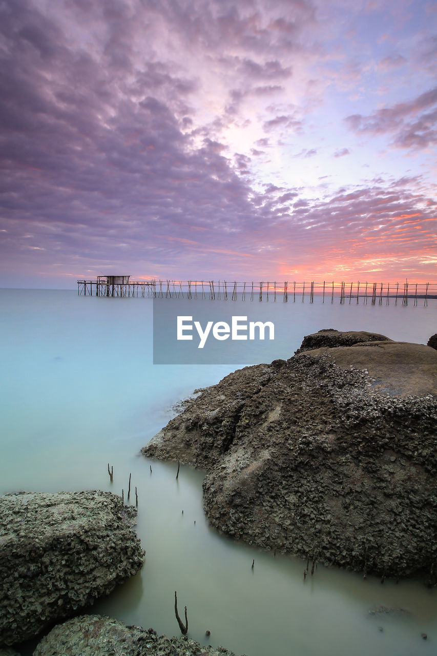 Scenic view of sea against sky at sunset