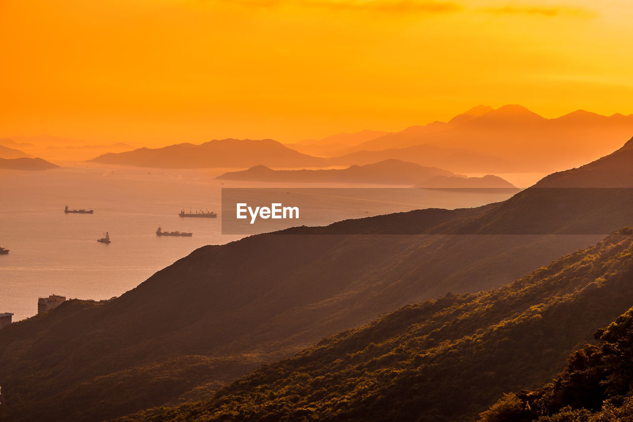 Scenic view of mountains and sea during sunset