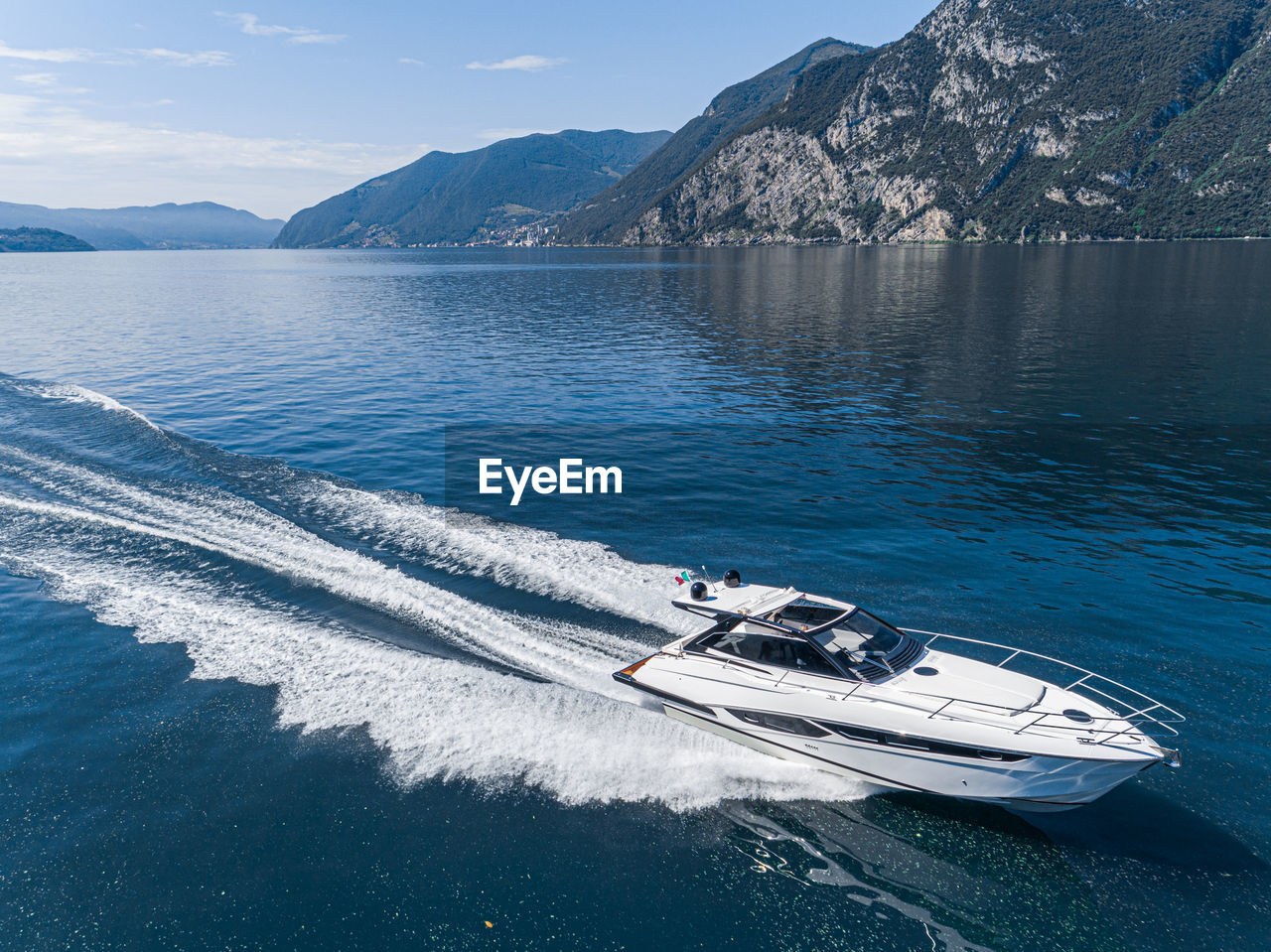 HIGH ANGLE VIEW OF NAUTICAL VESSEL ON SEA BY MOUNTAIN