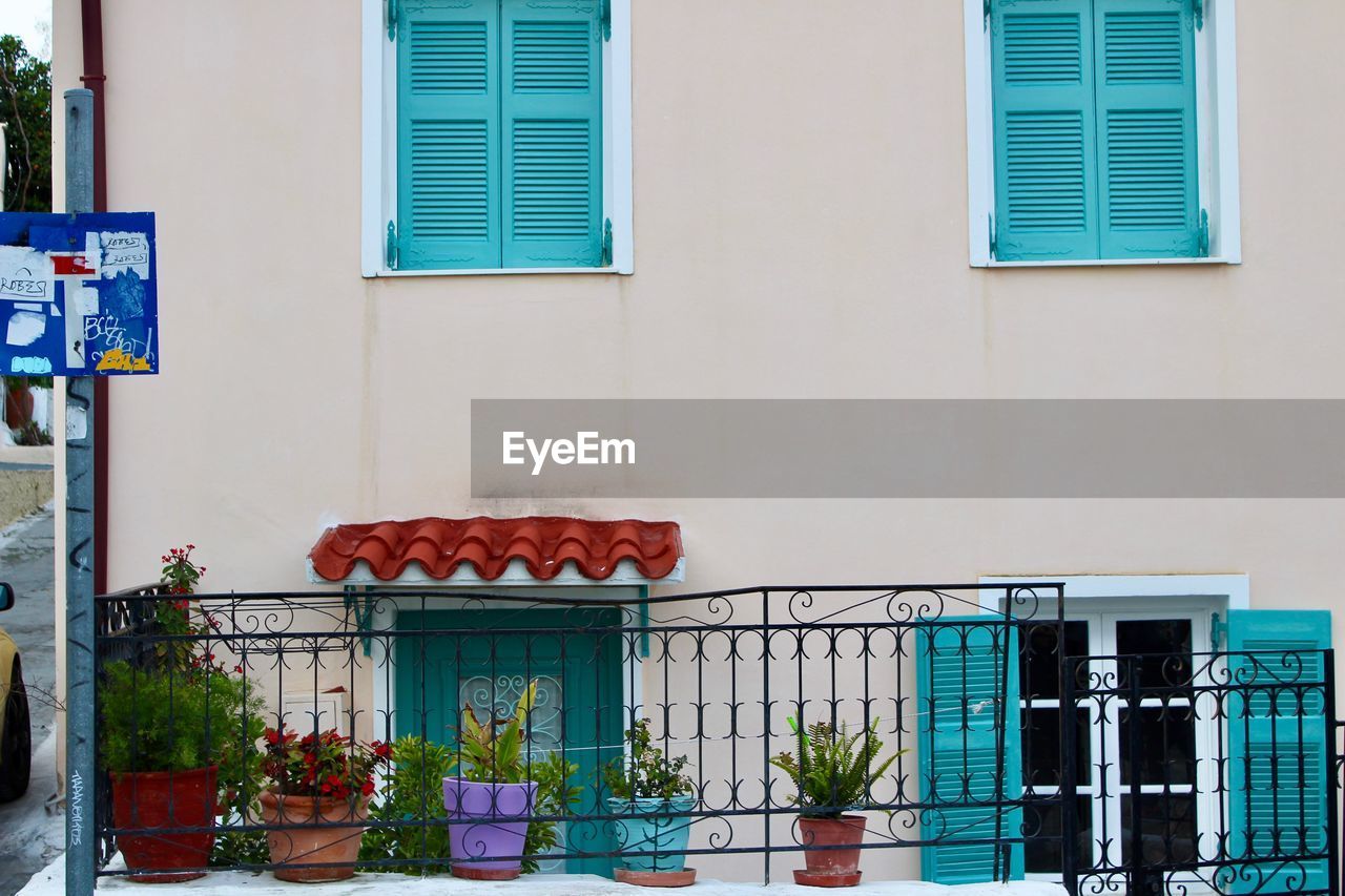 POTTED PLANT ON WINDOW BY BUILDING