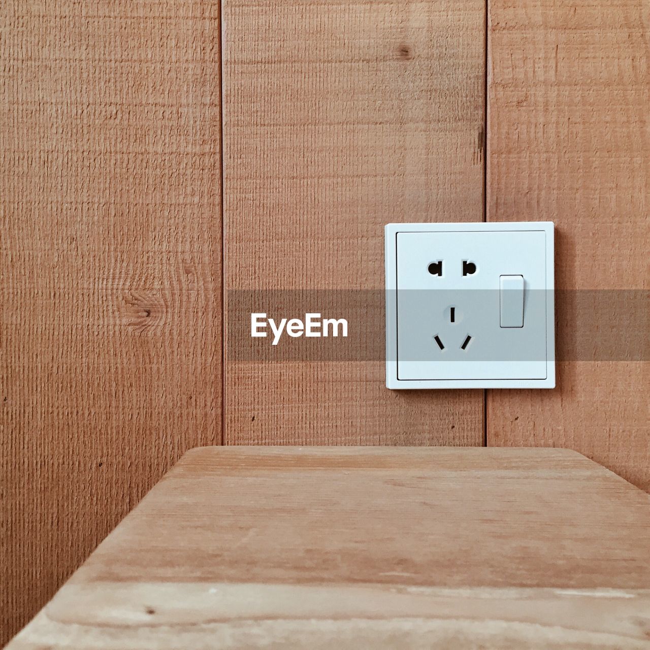 Close-up of switch on wooden wall