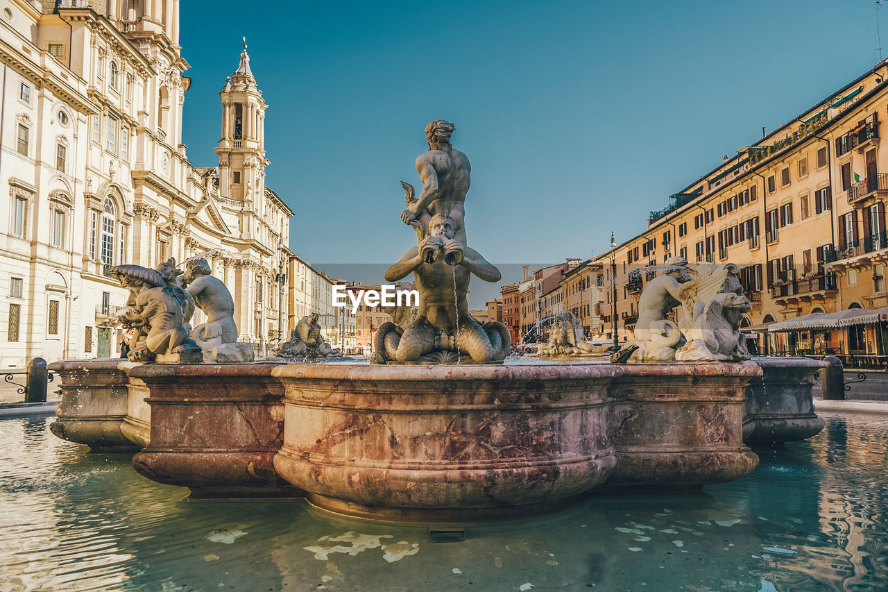 Low angle view of fountain in city