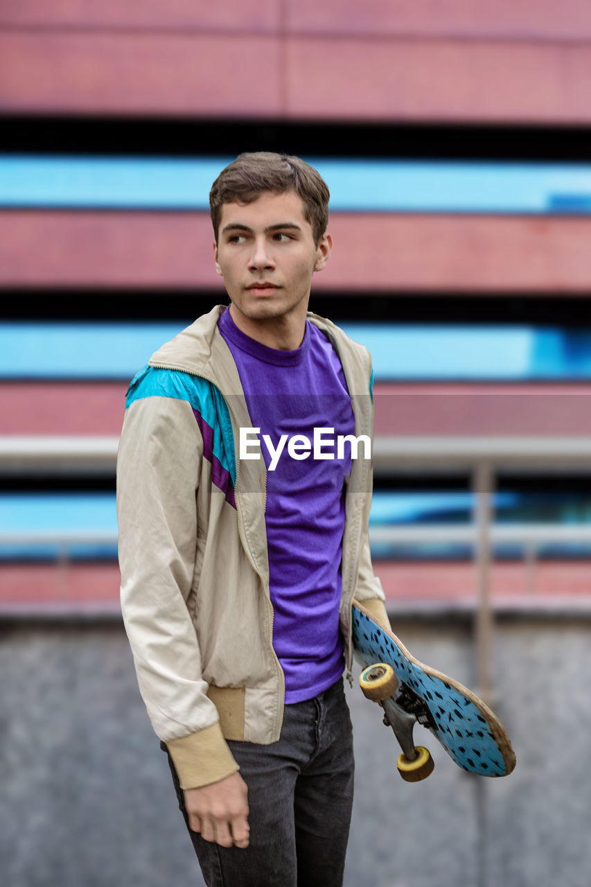 A teenager skateboarder. teenager with a skateboard wearing casual clothing. skater boy portrait.