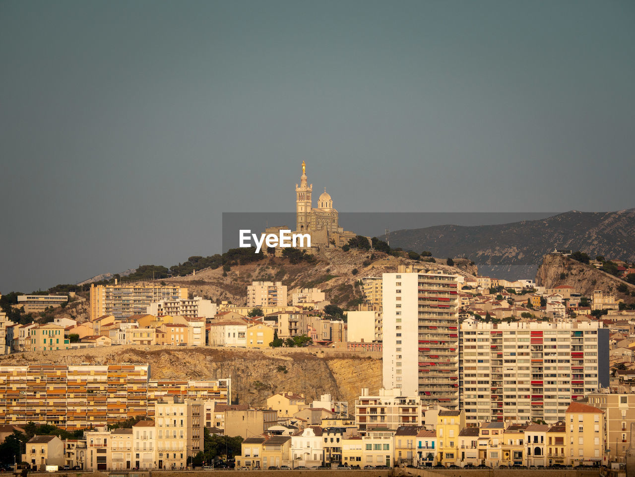 Buildings in city against clear sky