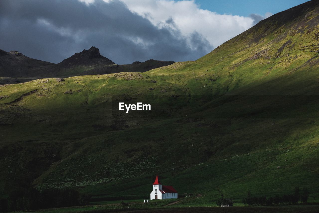 House on mountain against sky