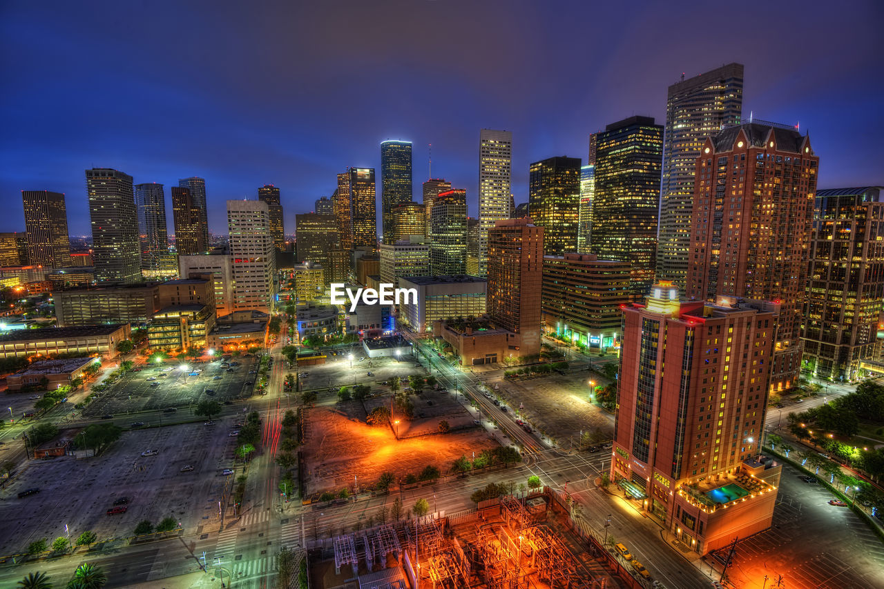 Aerial view of illuminated city buildings at night