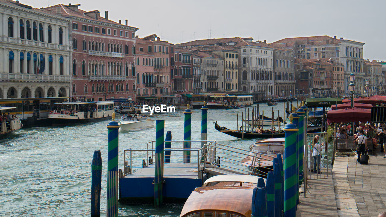 Boats in canal along built structures