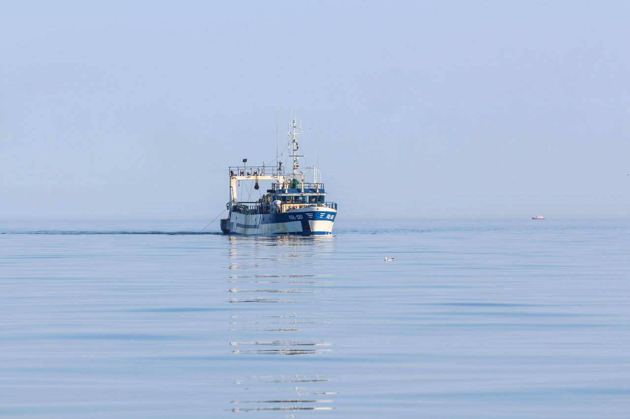 Boat in sea against clear sky