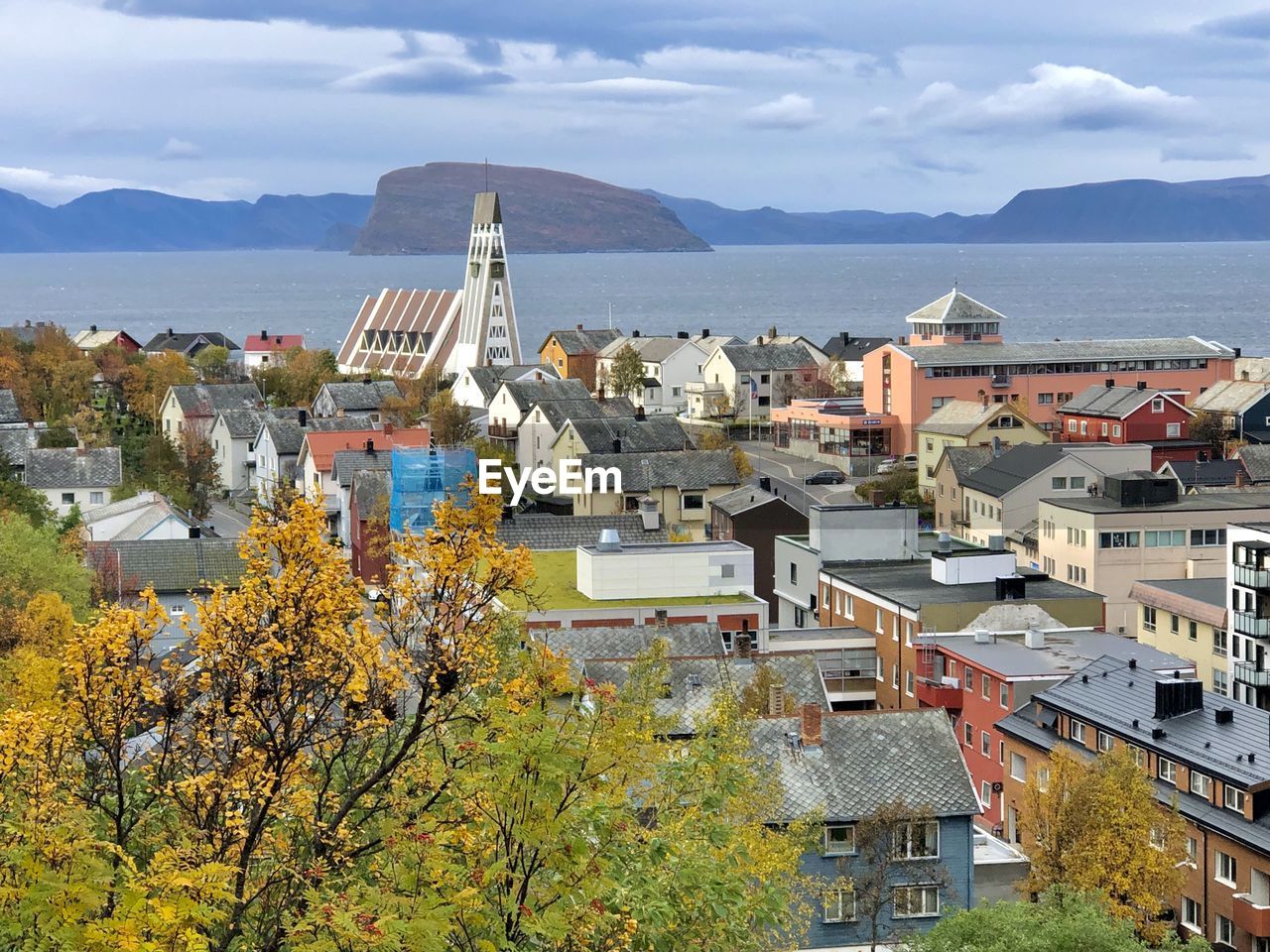 High angle view of townscape by sea against sky