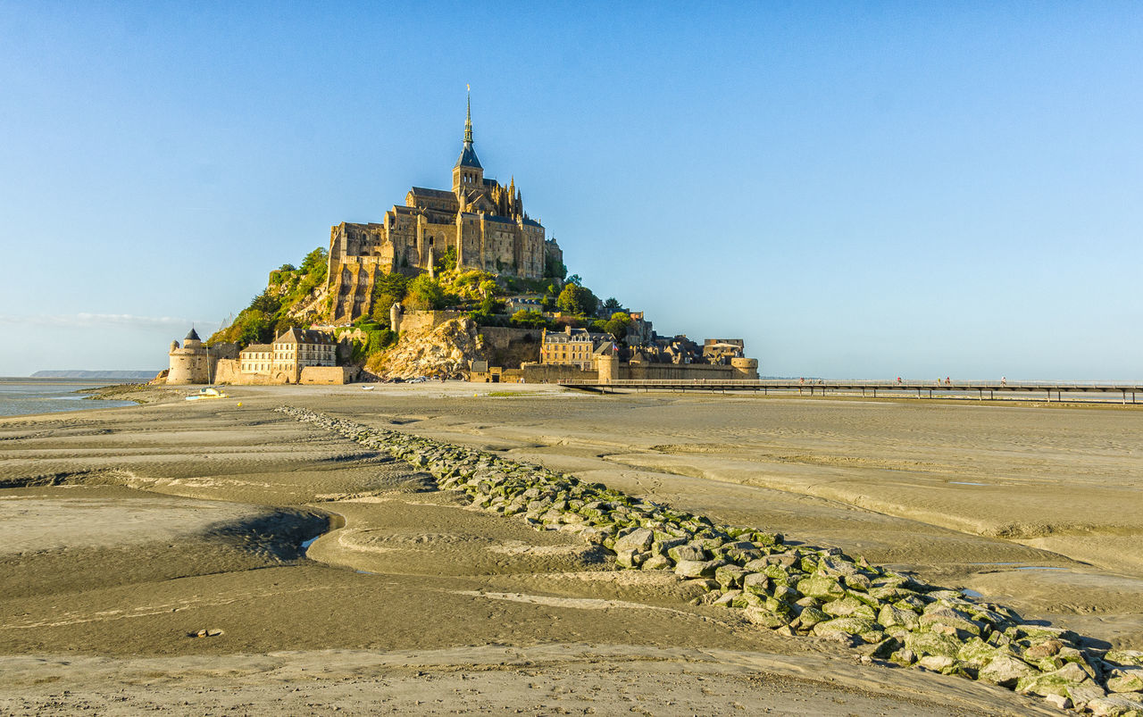 Mont saint-michel at beach against sky