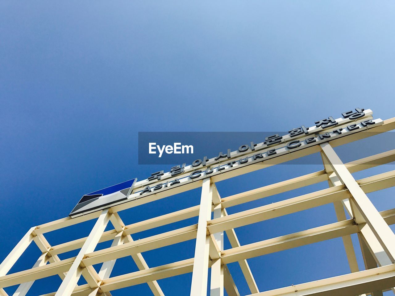 LOW ANGLE VIEW OF ROOF AGAINST BUILDING AGAINST CLEAR BLUE SKY