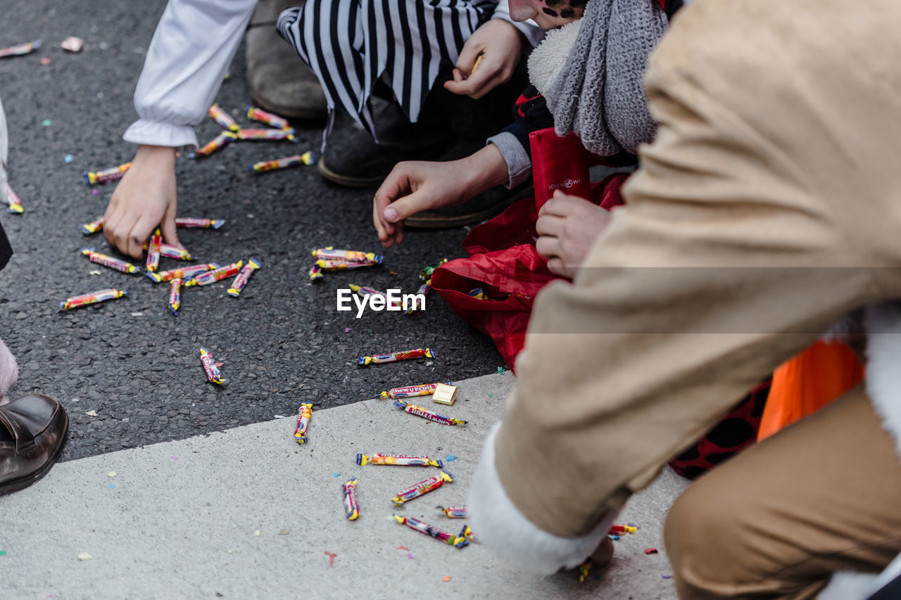 High angle view of people picking candies from street during carnival