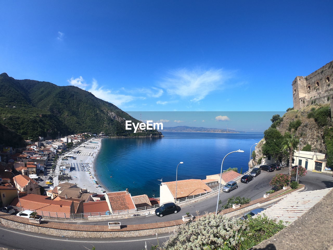 HIGH ANGLE VIEW OF BUILDINGS AND SEA AGAINST SKY