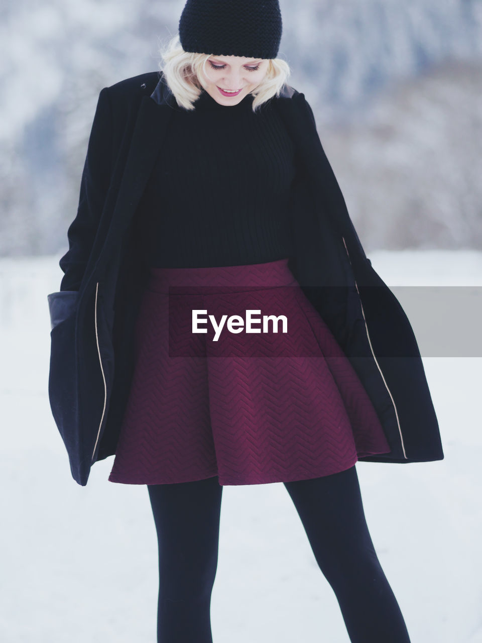 Mid adult woman standing on snow covered mountain