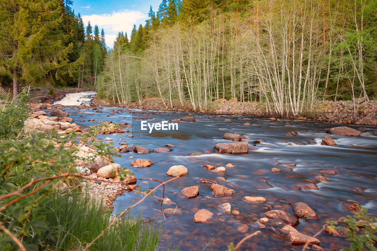 River landscape in the swedish vaermland with a stony river bed, taken with a long exposure