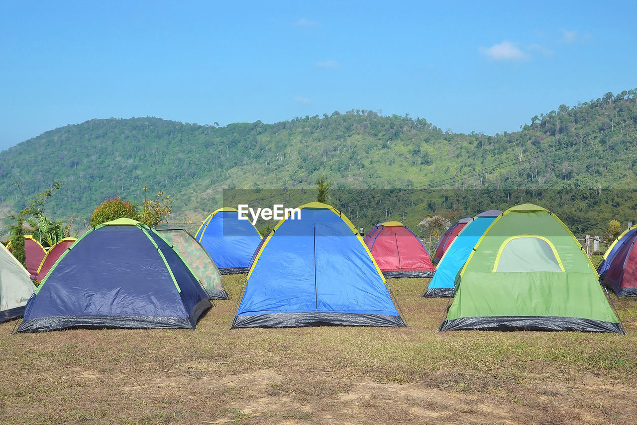 TENT ON FIELD AGAINST SKY