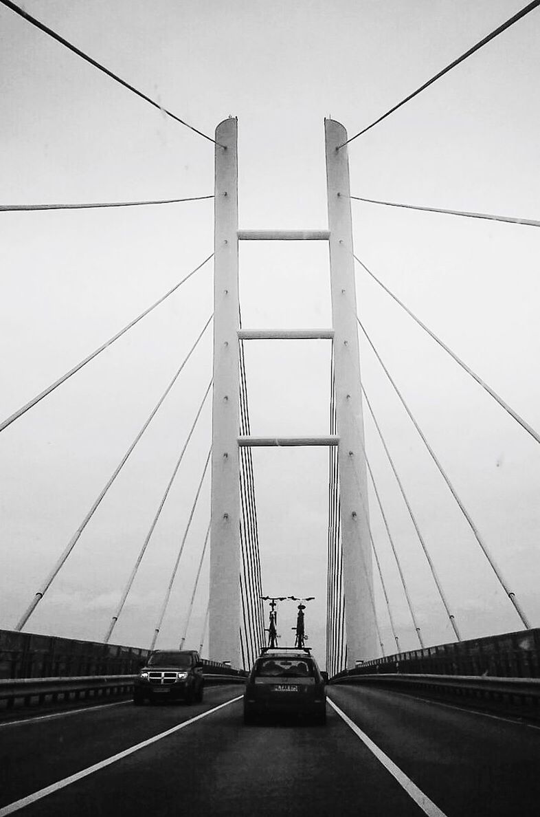 LOW ANGLE VIEW OF SUSPENSION BRIDGE AGAINST SKY