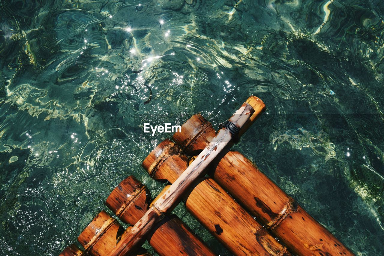 Extreme close-up of wooden raft in water