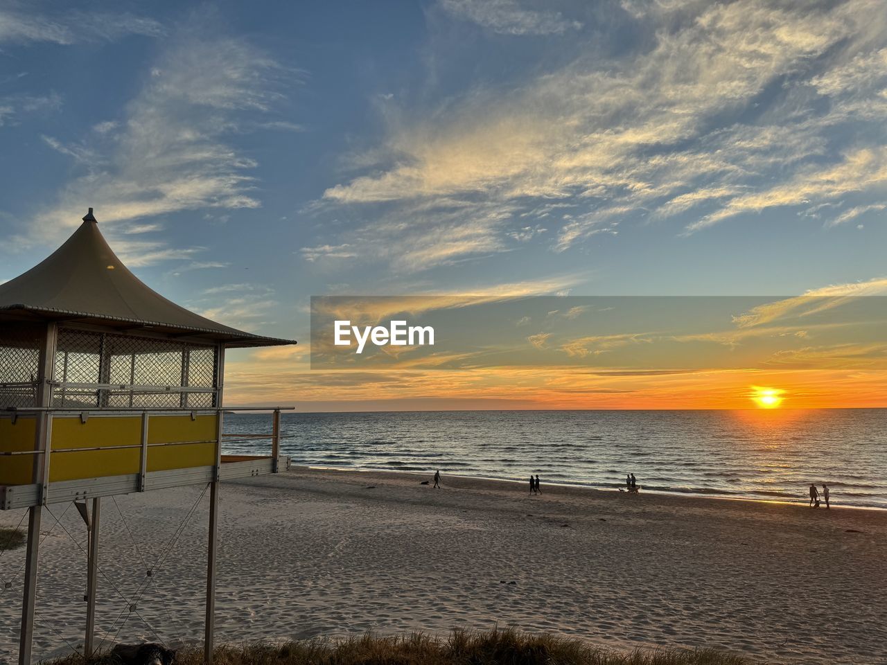 sky, sea, water, beach, land, ocean, sunset, horizon, beauty in nature, cloud, nature, scenics - nature, shore, horizon over water, sand, tranquility, coast, hut, tranquil scene, architecture, travel destinations, dusk, sunlight, evening, built structure, vacation, trip, holiday, idyllic, sun, wave, body of water, travel, outdoors, no people, lifeguard hut, coastline, summer, tourism, seascape, pier, man made structure, environment, beach hut, lifeguard