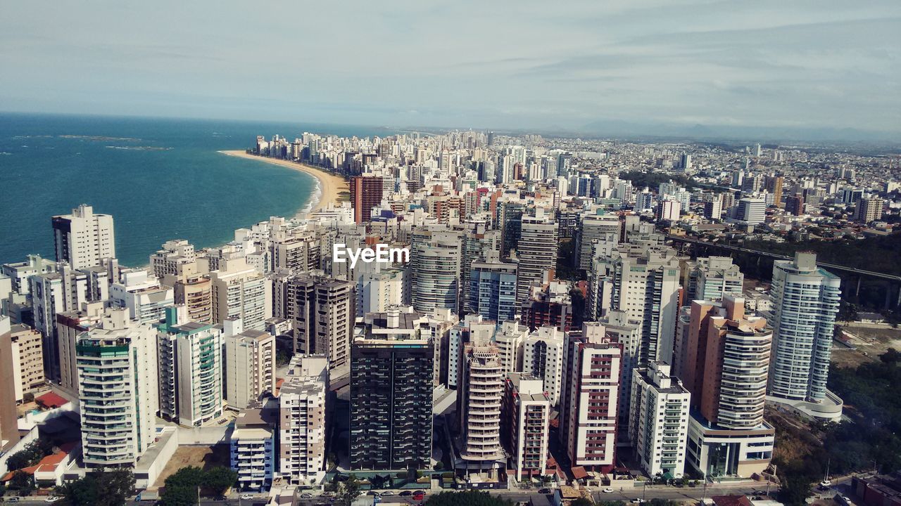 High angle view of modern buildings in city against sky