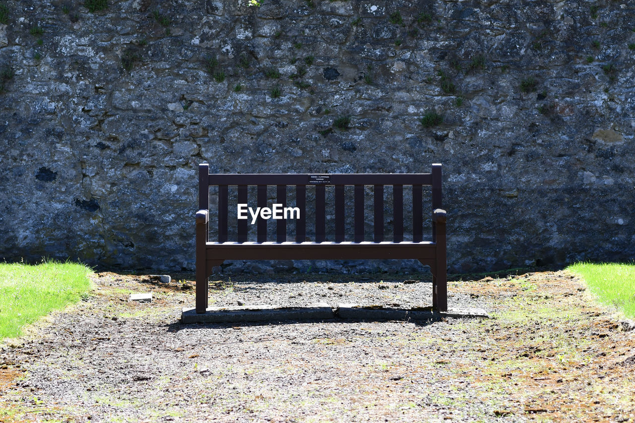 EMPTY BENCH IN PARK DURING RAINY SEASON