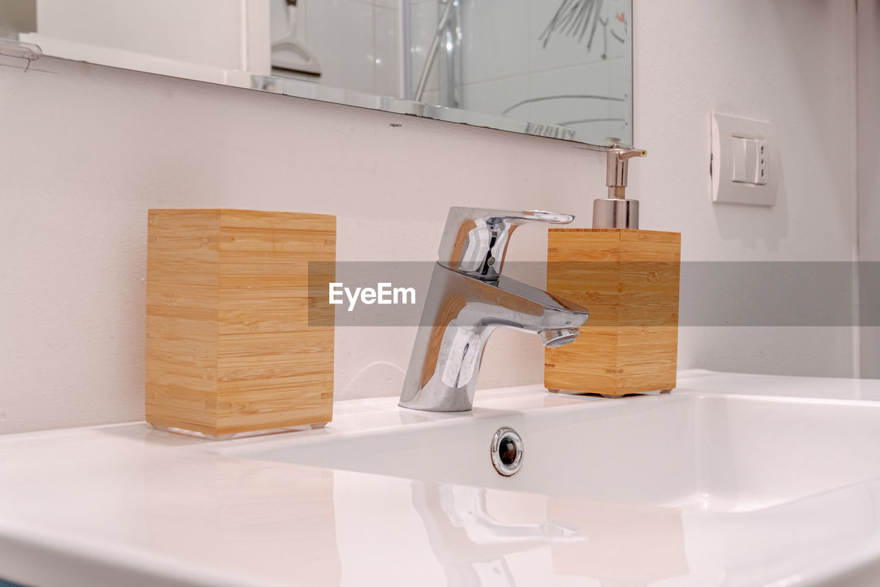 Sink in bathroom with wooden soap dispenser