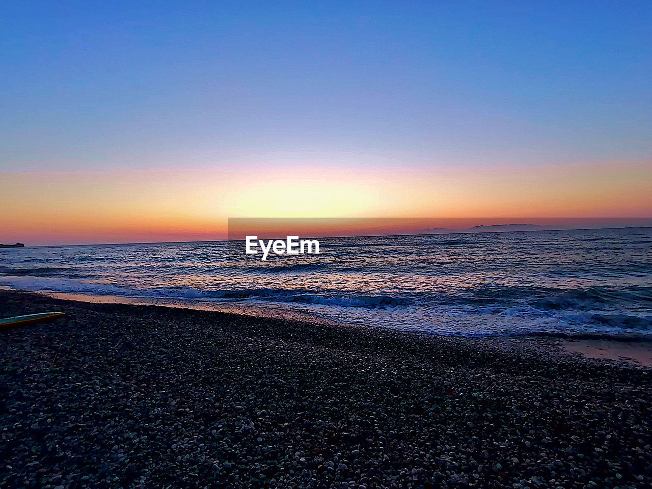 SCENIC VIEW OF BEACH DURING SUNSET