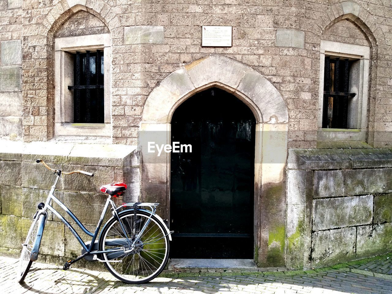 BICYCLE ON DOOR OF BUILDING