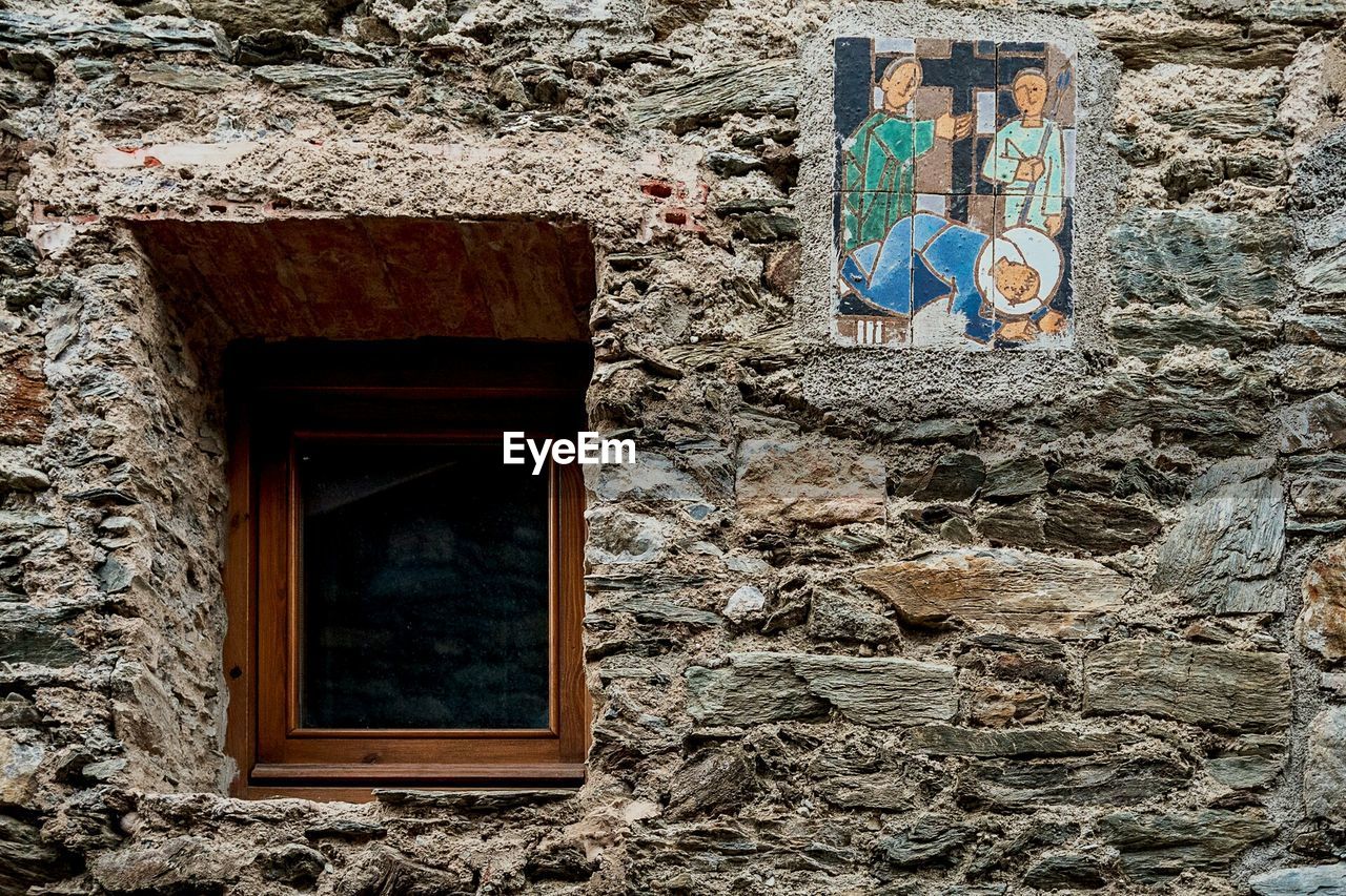 Religious picture frame on stone wall